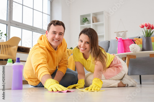 Happy couple cleaning home ...