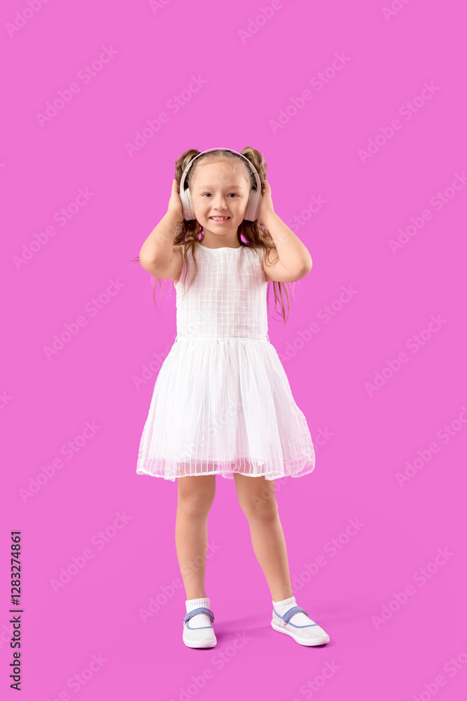 Cute little girl in headphones on violet background Cute little girl in headphones on violet background