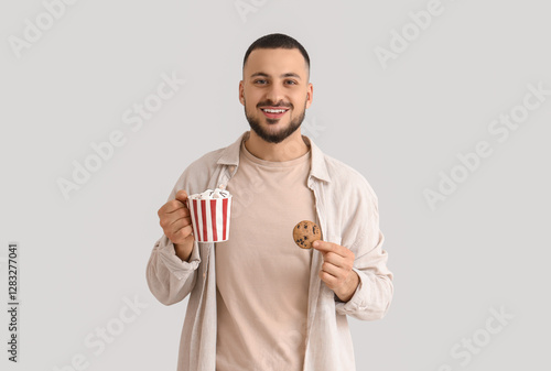 Young man with cup of cocoa...