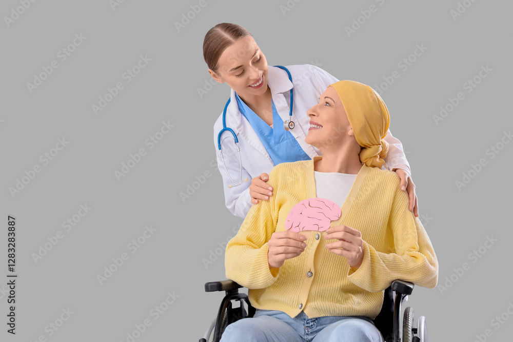Mature woman after chemotherapy in wheelchair with paper brain and doctor on light background Mature woman after chemotherapy in wheelchair with paper brain and doctor on light background