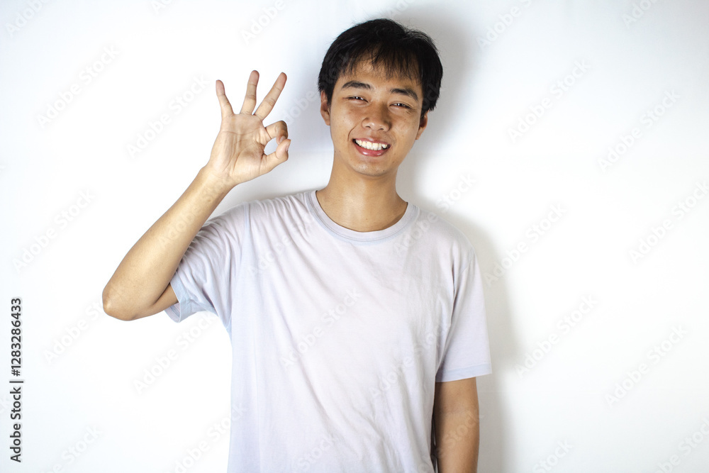 Asian teenager in white t-shirt is posing Asian teenager in white t-shirt is posing