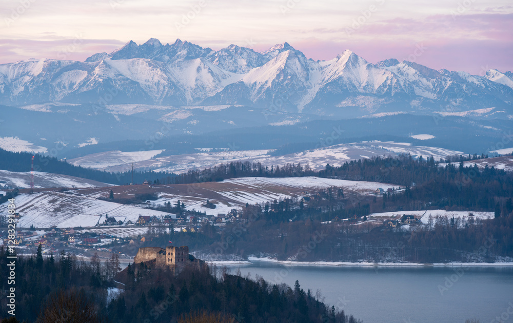 view on Tatra mountains and Czorsztyn castle during winter sunrise in Poland