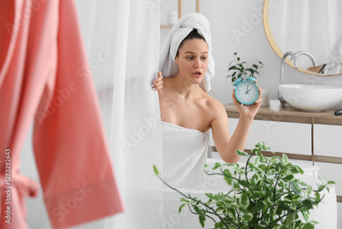 Late young woman with alarm...