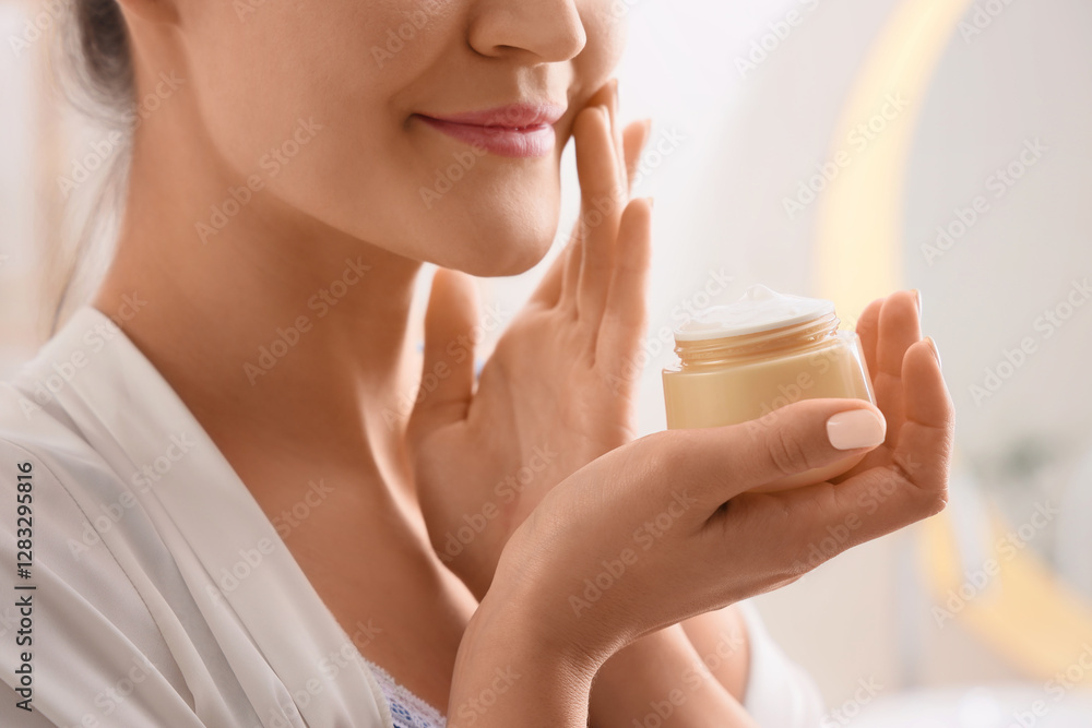 Young woman with jar of facial cream in bathroom, closeup Young woman with jar of facial cream in bathroom, closeup