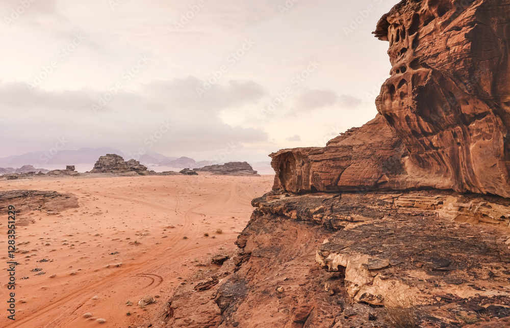 Red orange Mars like landscape in Jordan Wadi Rum desert, mountains background, overcast morning. This location was used as set for many science fiction movies