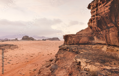 Red orange Mars like landscape in Jordan Wadi Rum desert, mountains background, overcast morning. This location was used as set for many science fiction movies photo