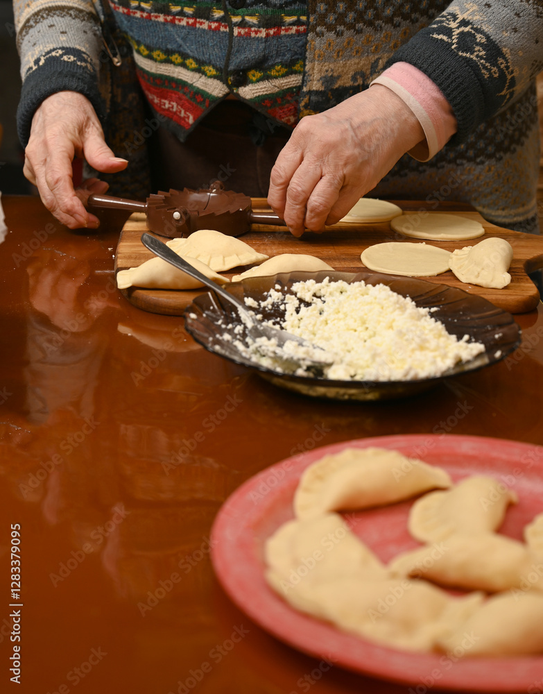 Woman skillfully fills dough circles with cheese in a warm kitchen