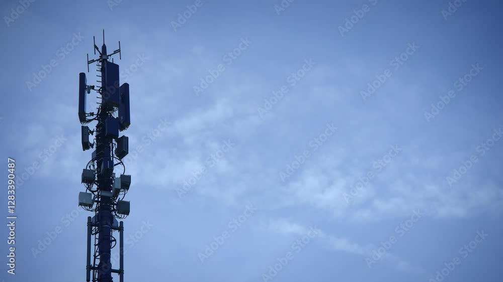 A Communication Tower Standing Tall Against a Bright and Clear Sky, Radiating Signals A Communication Tower Standing Tall Against a Bright and Clear Sky, Radiating Signals