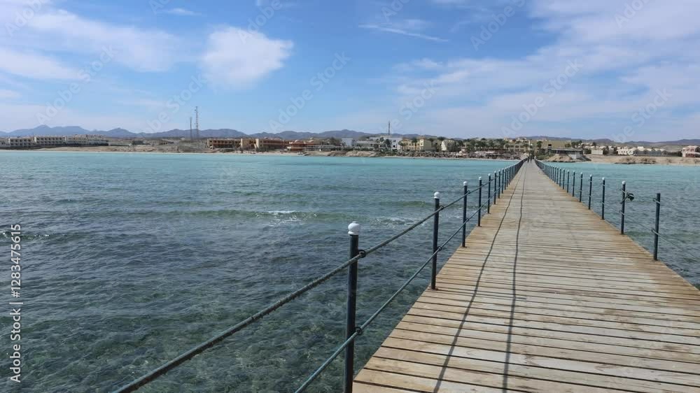 Wooden pier extending into marsa alam's turquoise waters Wooden pier extending into marsa alam's turquoise waters