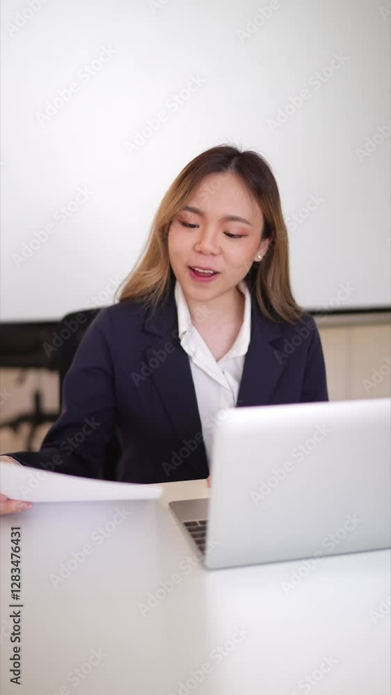 Asian businesswoman presenting ideas during an online meeting in a bright office space Asian businesswoman presenting ideas during an online meeting in a bright office space