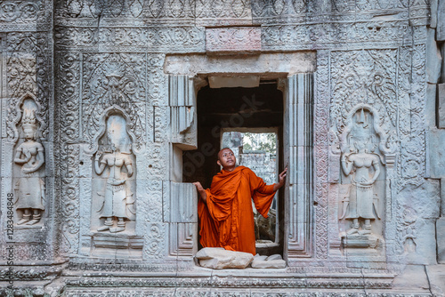 Monk looking out of a window in a temple, Angkor, Cambodia photo