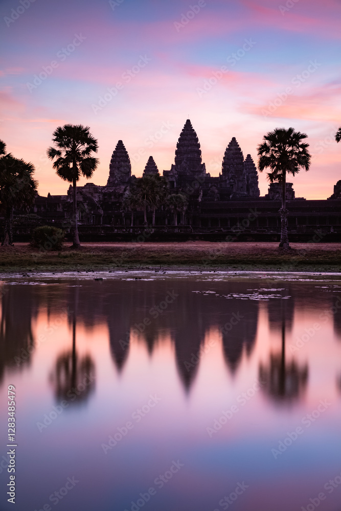 Angkor Wat temples at sunrise reflected into water, Cambodia