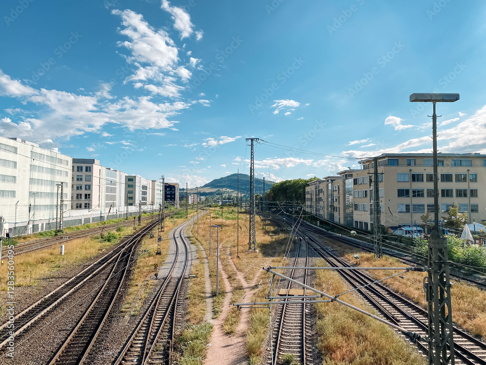 Train track with a city in the background Train track with a city in the background