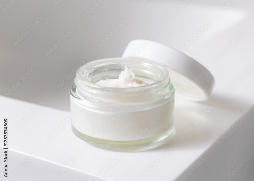 Opened cream jar with a lid on white basin in bathroom close up, cosmetic mockup Opened cream jar with a lid on white basin in bathroom close up, cosmetic mockup