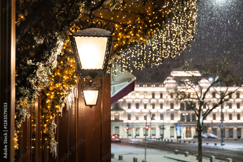 Winter in Bucharest. A snow-covered street in Bucharest illuminated by vintage street lamps, casting warm light on the cold winter night.