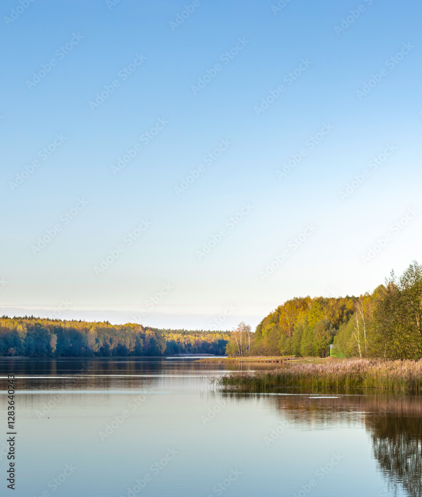 Calm lake with trees in the background Calm lake with trees in the background