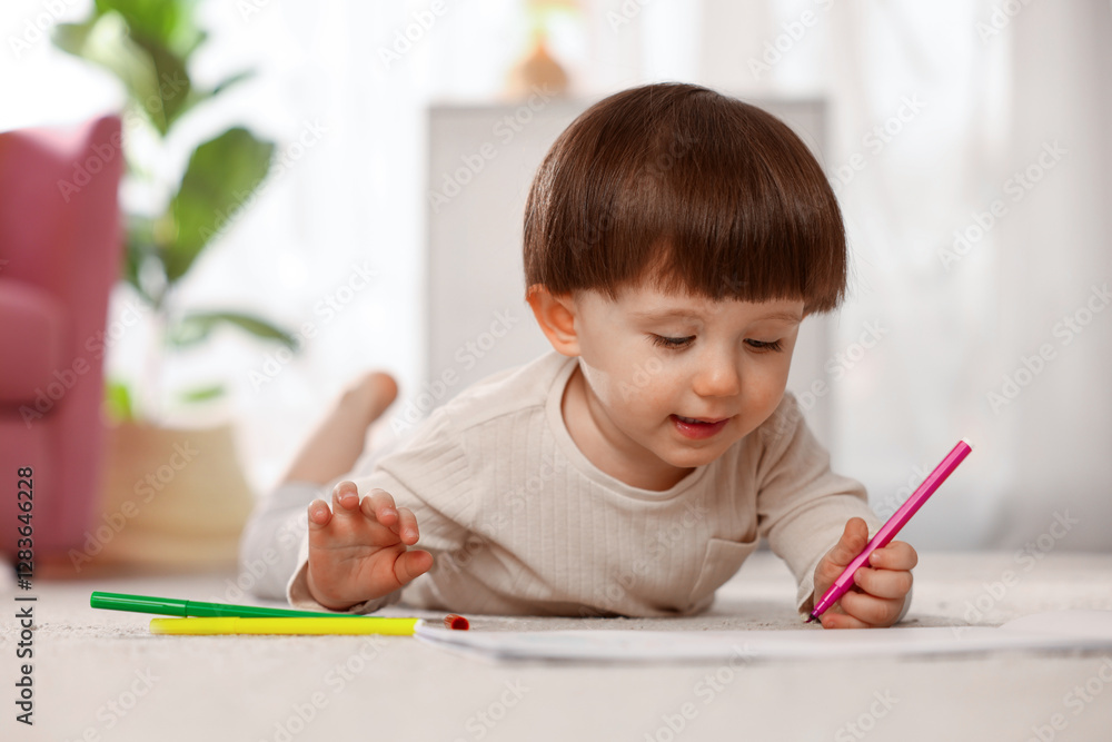 Cute little boy drawing on floor at home Cute little boy drawing on floor at home