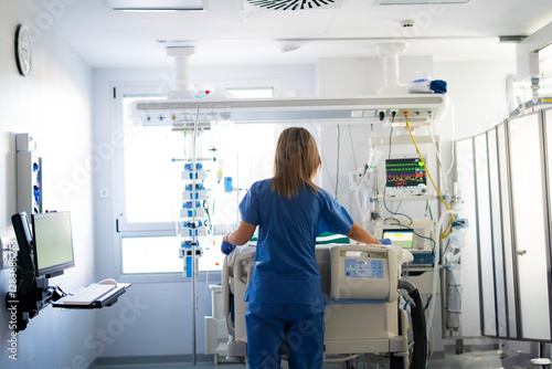icu nurse talking on the phone in a critical care unit