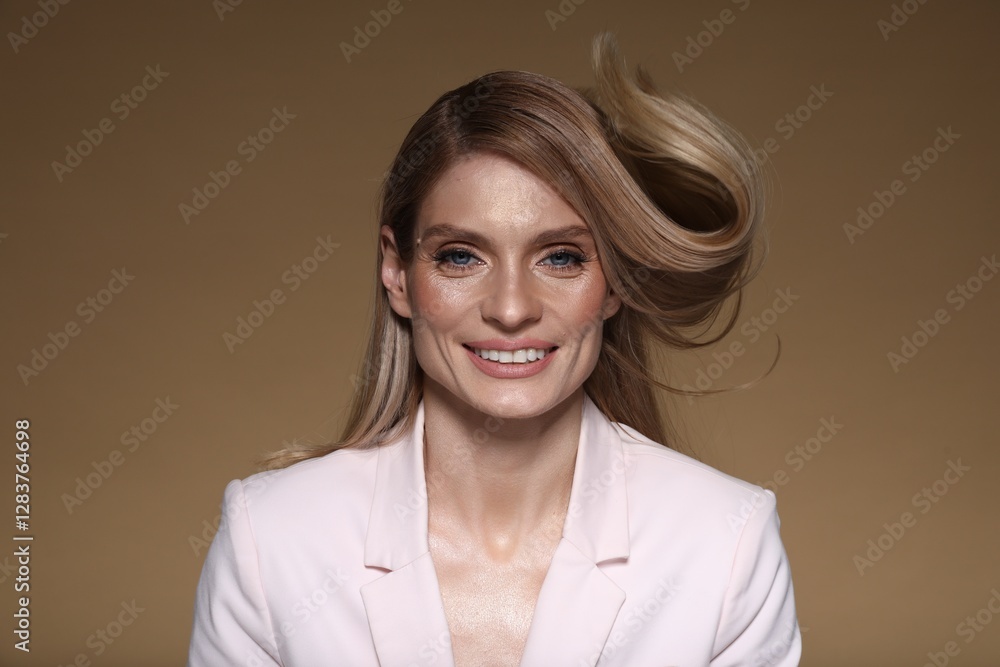 Portrait of beautiful happy woman with straight blonde hair on light brown background Portrait of beautiful happy woman with straight blonde hair on light brown background