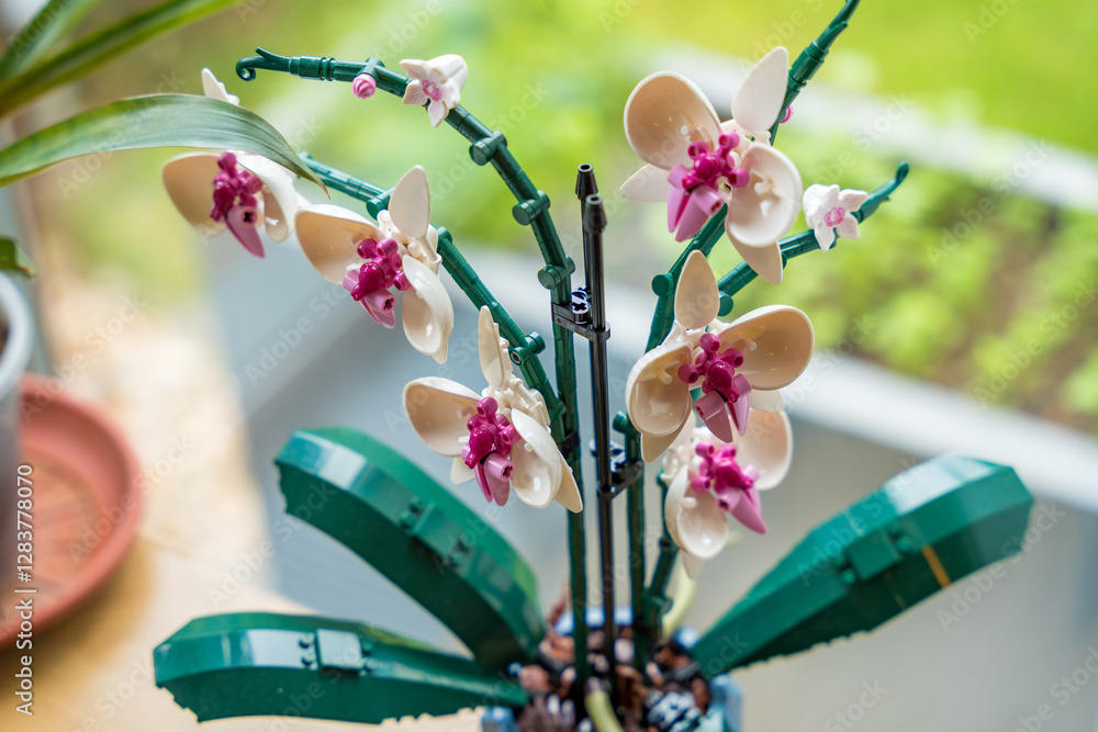 Obraz premium Prague, Czech republic - May 8, 2024: A close-up of a plastic decorative orchid constructed from Lego bricks, offering a unique, durable, and sustainable alternative to fresh flowers.