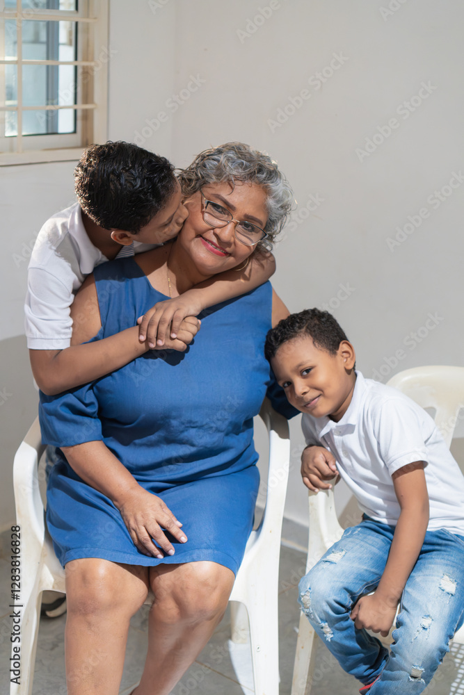 Fototapeta premium Grandchildren showing affection to their grandmother at home