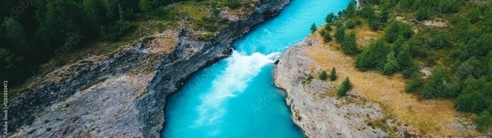 Serene Aerial View of River Flowing Through Rocky Landscape Serene Aerial View of River Flowing Through Rocky Landscape