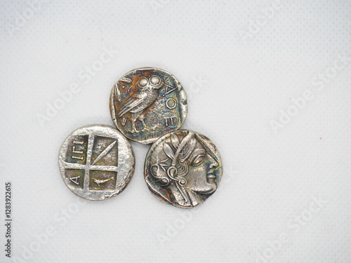 Greek silver coins, Athenian owl and Aegina turtle.
