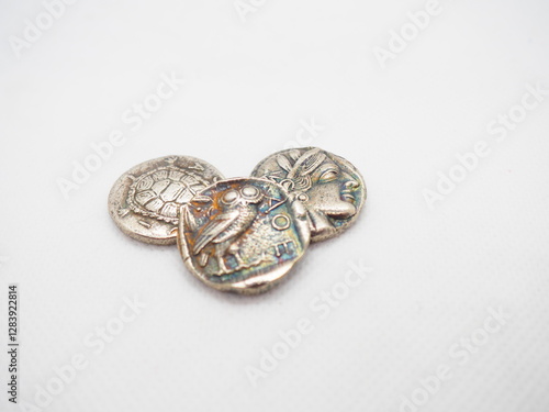 Greek silver coins, Athenian owl and Aegina turtle.