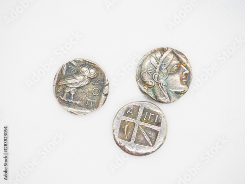 Greek silver coins, Athenian owl and Aegina turtle.
