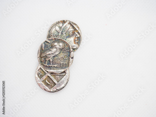 Greek silver coins, Athenian owl and Aegina turtle.