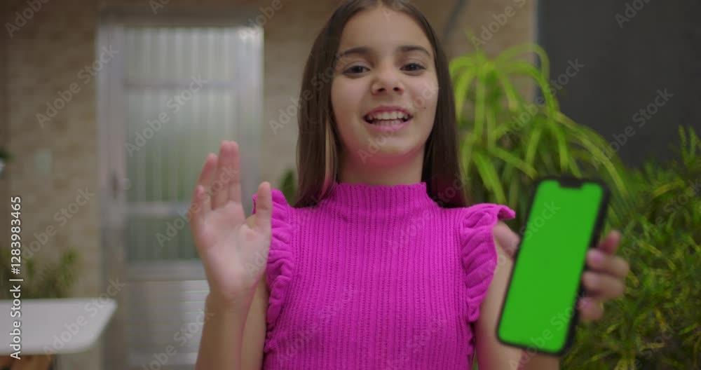 Young girl smiling and pointing at smartphone with green screen and chroma key in an outdoor setting, emphasizing customizable display for digital content or advertising Young girl smiling and pointing at smartphone with green screen and chroma key in an outdoor setting, emphasizing customizable display for digital content or advertising