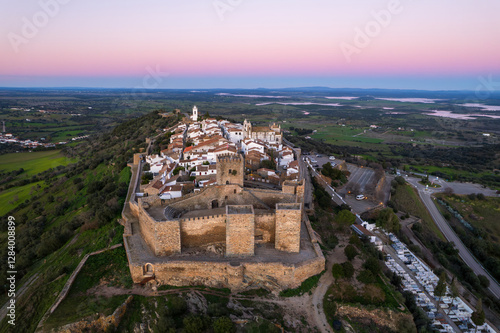 Amazing aerial view of the medieval village of Monsaraz, Alentejo, Portugal. Beautiful landscape at sunset. Historic castle, tourist attraction and holiday travel destination.