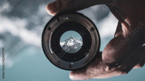 Snowcapped mountain visible through camera lens