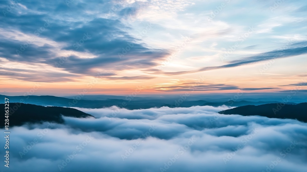 Obraz premium Stunning aerial view of mountains and valleys covered in low clouds during a vibrant sunset : Generative AI