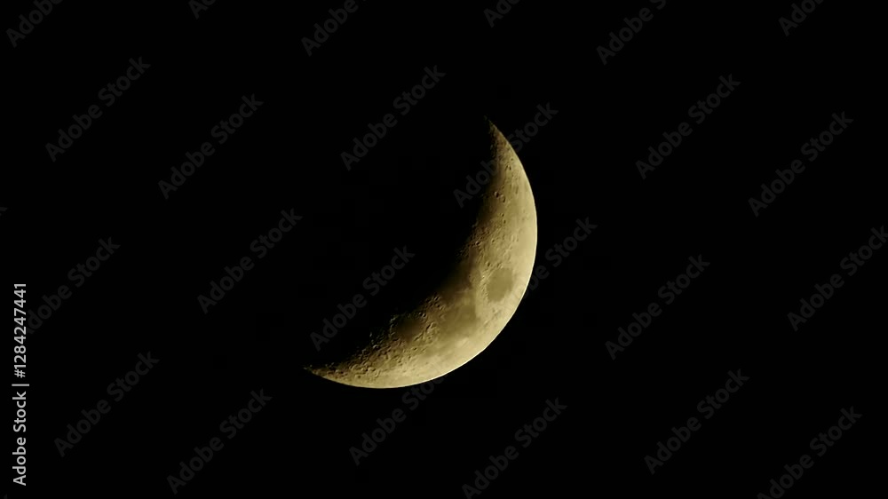 A crescent moon shines in the night sky, a celestial event A crescent moon shines in the night sky, a celestial event