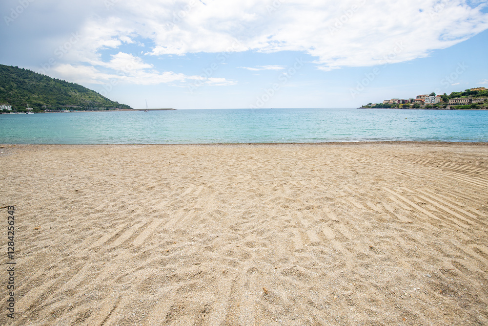 Beach and sea with hills in the background, bay and coast with a holiday resort in southern Italy Beach and sea with hills in the background, bay and coast with a holiday resort in southern Italy