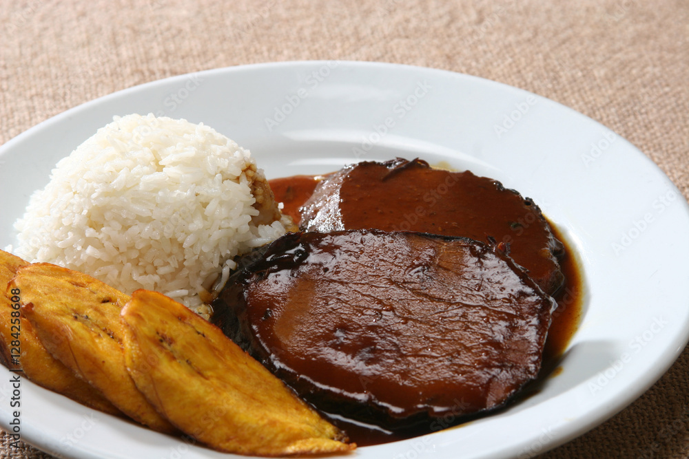 Venezuelan asado negro—slow-braising beef in deep caramelized sauce, accompanying white rice and crispy plantain slices Venezuelan asado negro—slow-braising beef in deep caramelized sauce, accompanying white rice and crispy plantain slices