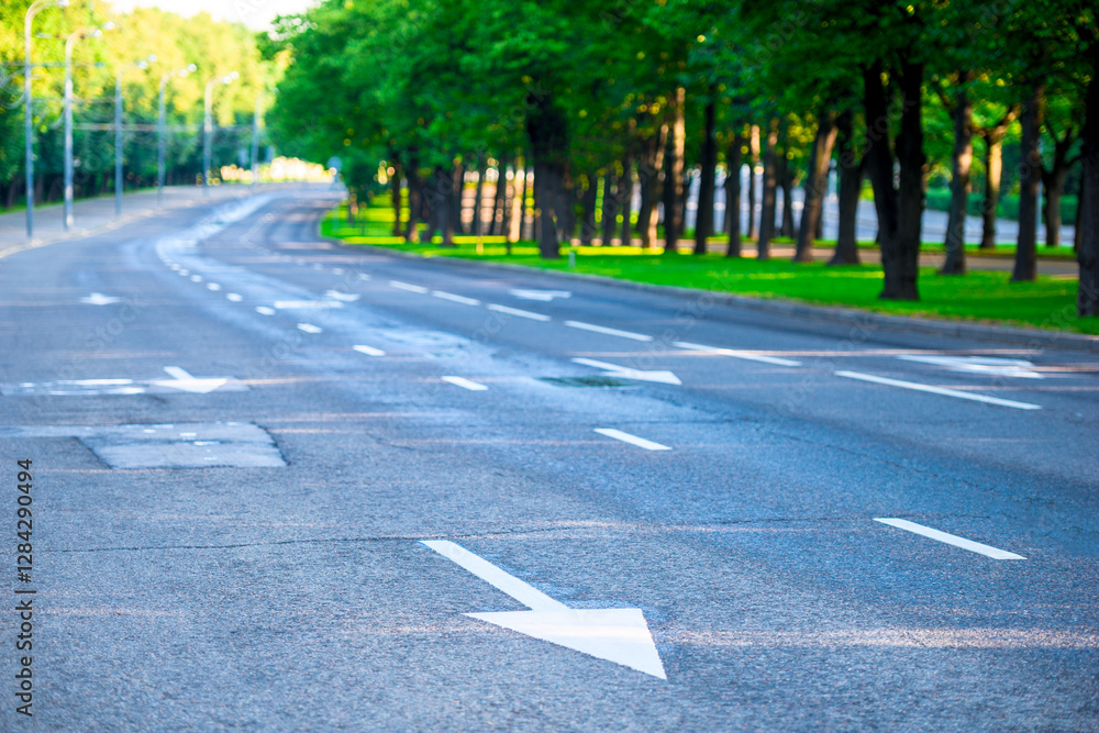 An empty paved road with markings early in the morning on a fine sunny day