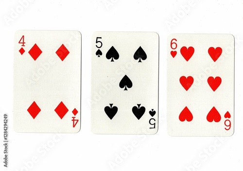 A hand of playing cards showing a run of three on a white background. photo