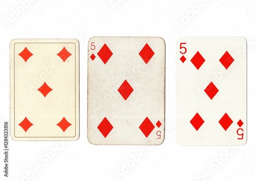 Vintage playing cards in three different designs showing the same value. photo