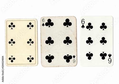 Vintage playing cards in three different designs showing the same value. photo