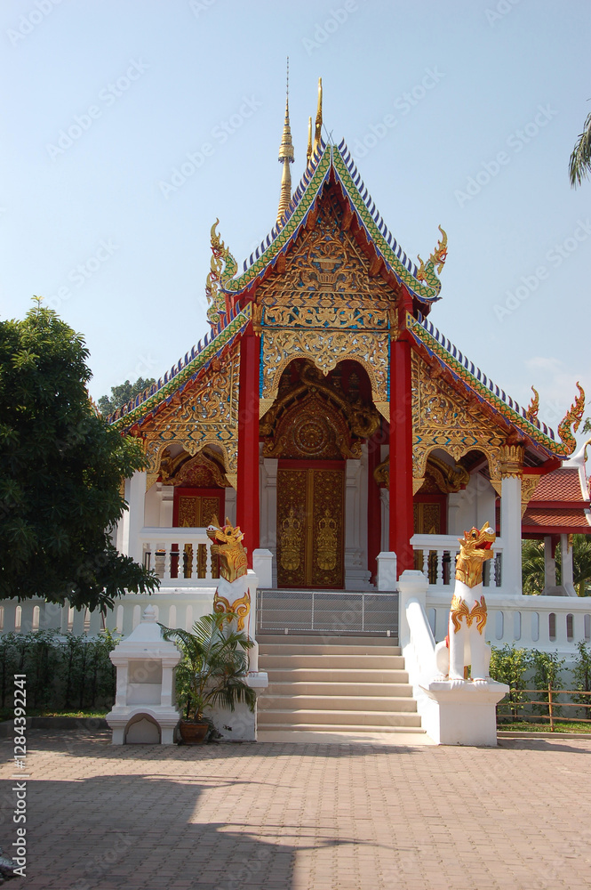 Ornate Buddhist temple in Chiang Mai, Thailand, featuring intricate golden carvings and traditional Lanna-style architecture. Ornate Buddhist temple in Chiang Mai, Thailand, featuring intricate golden carvings and traditional Lanna-style architecture.