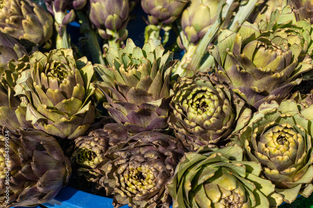 Fototapeta premium Fresh artichokes arranged in a vibrant market setting during midday harvest season