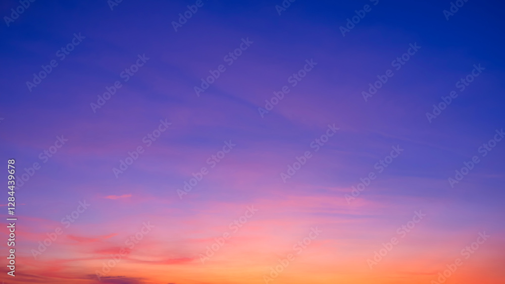 Obraz premium Twilight sky background with pink clouds on colorful orange and blue romantic evening sky after sundown