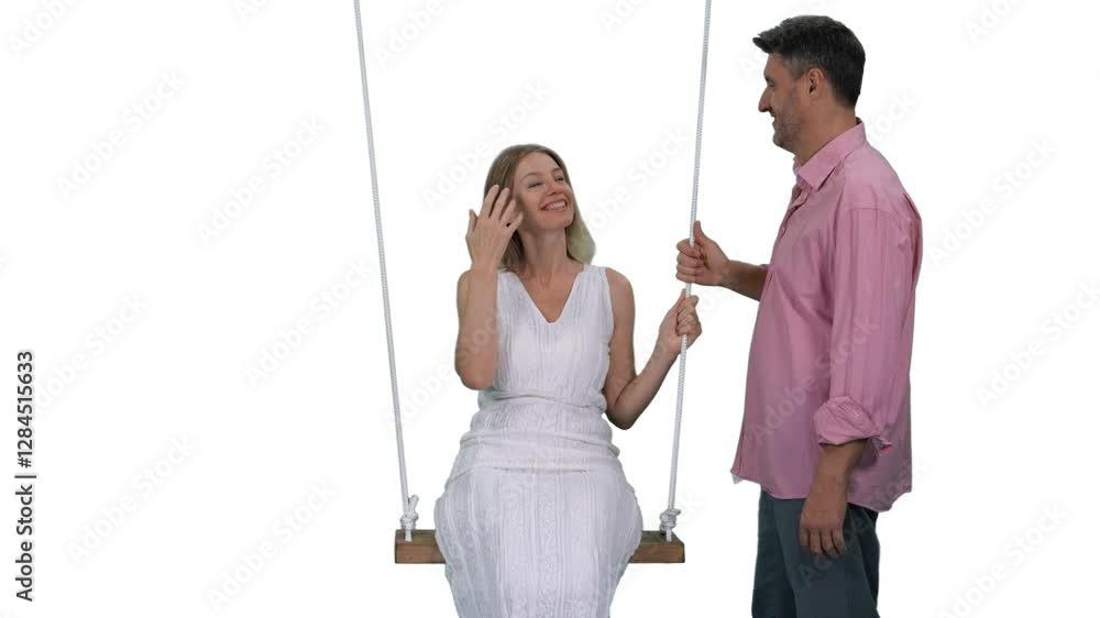 Adult man swinging smiling woman in white dress on beach swing, Full HD footage with alpha transparency channel isolated on white background Adult man swinging smiling woman in white dress on beach swing, Full HD footage with alpha transparency channel isolated on white background