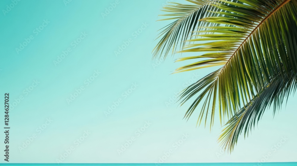 Fototapeta premium Lush tropical palm leaves swaying in the breeze on a sunny beach