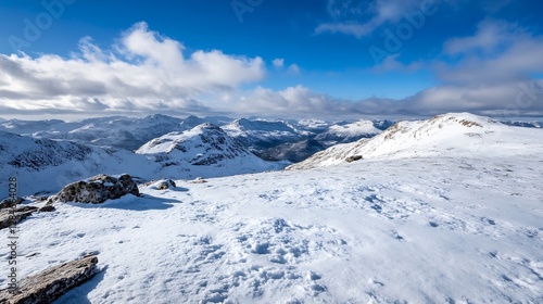 Majestic snowy mountain landscape with bright blue sky and dramatic clouds providing a stunning winter scenery : Generative AI