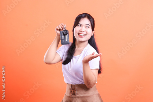 Принти на полотні Excited Asian woman showing off her new car keys with a big smile