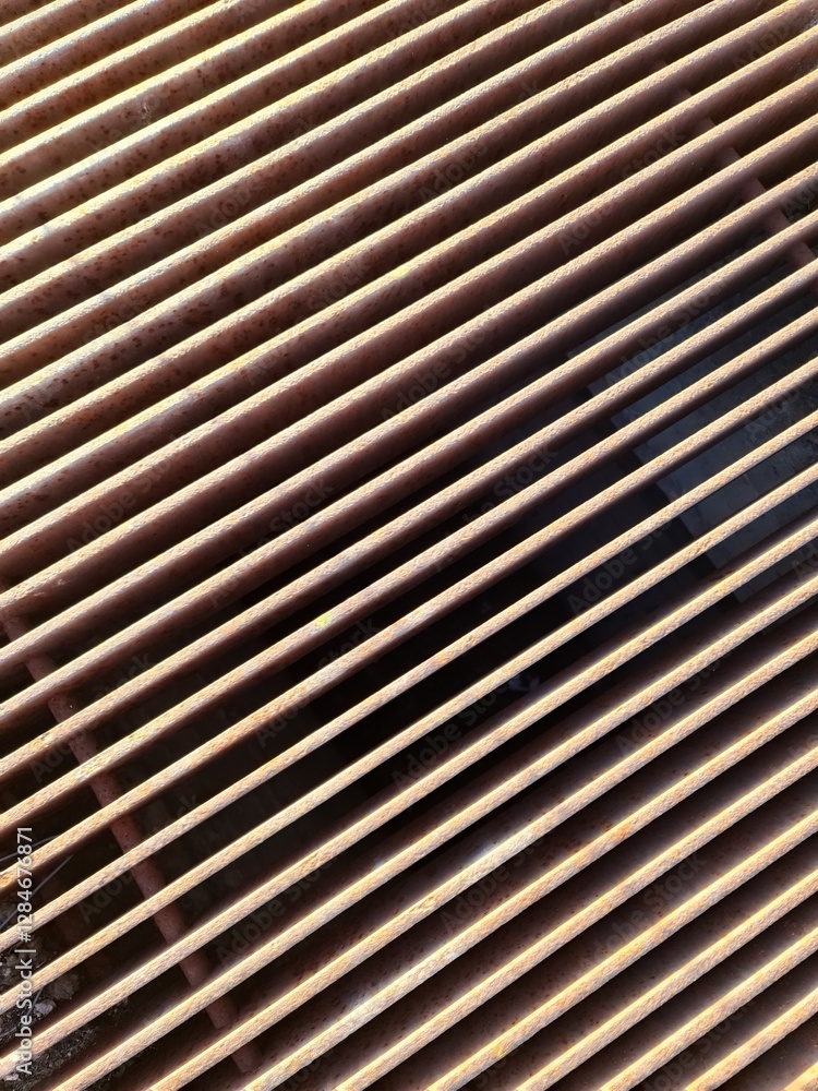 Rusty metal grate forming parallel lines creating an interesting visual pattern Rusty metal grate forming parallel lines creating an interesting visual pattern