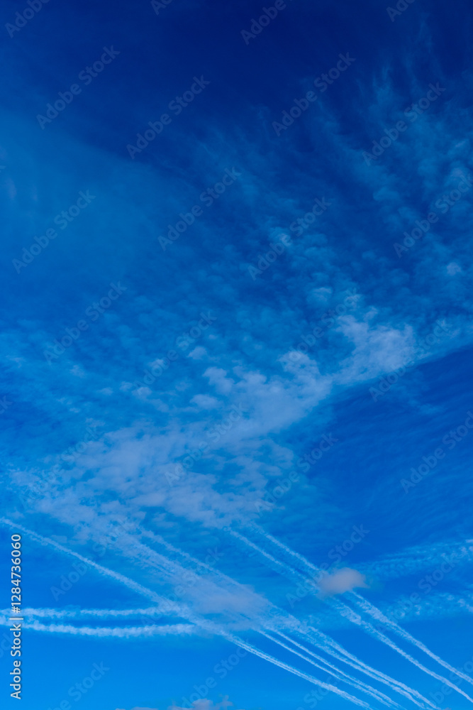 Condensation trails against a blue sky. Photo taken on a sunny day